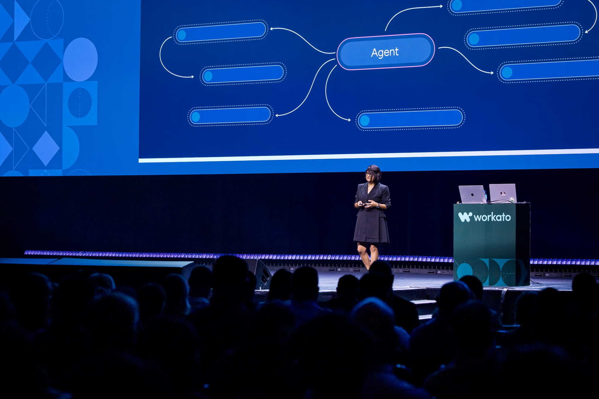 Nishtha presenting on stage at a Workato conference
